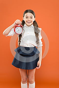 Elementary school day bell schedule. Schooltime concept. Avoid being late. Schoolgirl hold alarm clock. Time to study