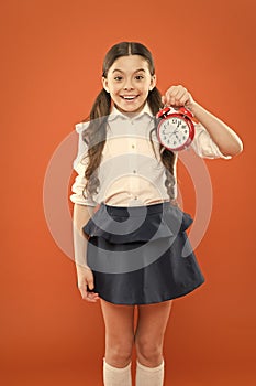 Elementary school day bell schedule. Schooltime concept. Avoid being late. Schoolgirl hold alarm clock. Time to study