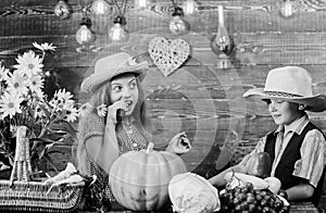 Elementary school fall festival idea. Children play vegetables pumpkin. Kids girl boy wear cowboy farmer style hat