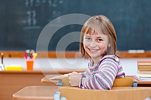 Elementary school girl turning back and smiling