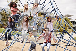 Elementary school kids climbing in the school playground