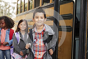 Elementary school kids queueing for the school bus photo