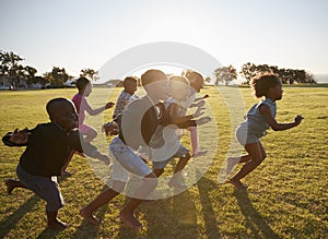 Elementary school kids running together in an open field