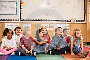 Elementary school kids sitting on classroom floor