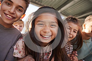 Elementary school kids smiling to camera, close up