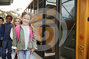 Elementary school kids waiting to board the school bus