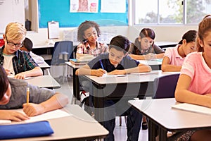 Elementary school kids working at their desks in a classroom