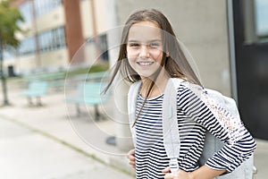 Elementary school pupil outside carrying rucksack