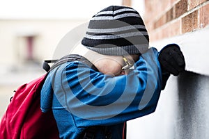 Elementary school pupil outside with rucksack