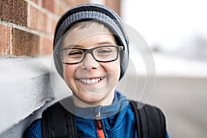 Elementary school pupil outside with rucksack