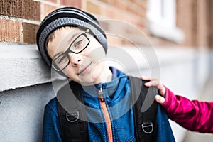 Elementary school pupil outside with rucksack