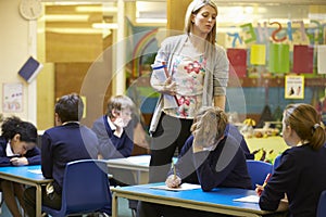 Elementary School Pupils Sitting Examination In Classroom