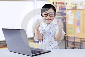 Elementary school student shows OK sign