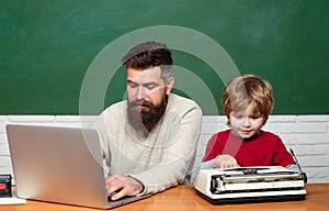 Elementary school teacher and student in classroom. Teacher helping pupils studying on desks in classroom. Concept of