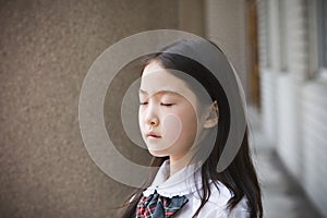 Elementary schoolgirl praying