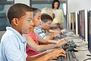 Elementary Students Working At Computers In Classroom