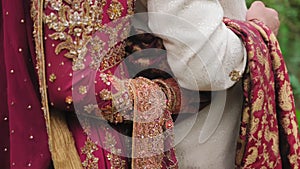 Elements of Beautiful woman dressed in traditional Indian hindu wedding. Couple standing together. Close up shot