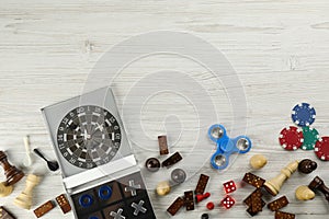 Elements of different board games on white wooden table, flat lay. Space for text