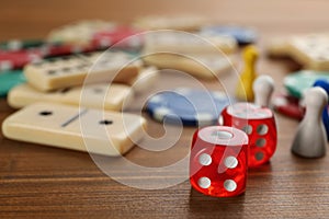 Elements of different board games on wooden table, closeup