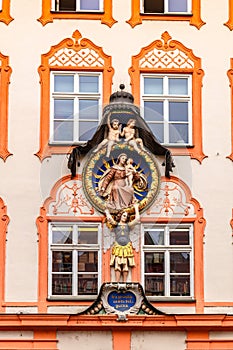 Elements of facade of house with bas-reliefs and old frescoes in Landshut, Bavaria, Germany