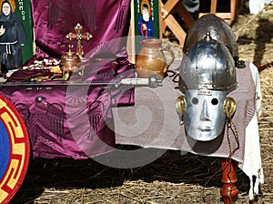 Elements of local Medieval fair, knight\'s equipment for battle, metal helmet and armour with sward, costume performance