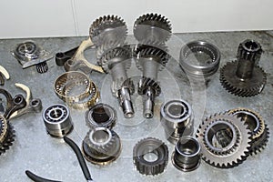 The elements of the manual transmission are placed on a metal table