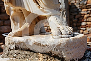 Elements of marble legs of an ancient statue of the ruined city of Ephesus in Turkey