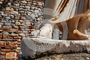 Elements of marble legs of an ancient statue of the ruined city of Ephesus in Turkey