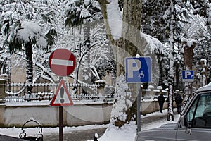 Elements road signs warning and Parking place in a snowy city