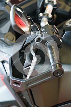 Elements of the steering wheel of a motorcycle. Clutch handle and mirror