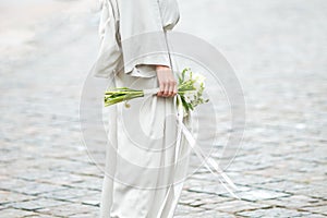 Elements of a woman`s casual suit with a bouquet of callas