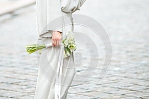 Elements of a woman`s casual suit with a bouquet of callas