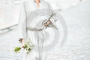 Elements of a woman`s casual suit with a bouquet of callas