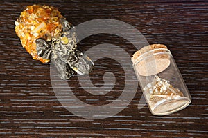 Elephant amber stone glass jar sand wooden background