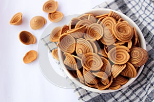 Elephant ear cake or kue kuping gajah, a traditional Indonesian cake served in a bowl. close up.