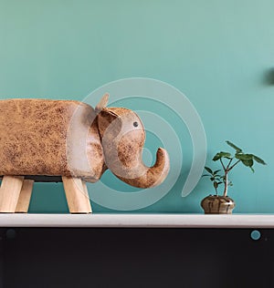 An elephant leather chair in front of a green background