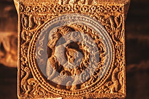 Elephant and lion on relief of the column, made in 7th century by Hindu sculptor inside the old temple, India