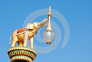 Elephant statue holding a lamp