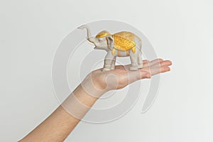 Elephant statuette on the hand isolated on white background.