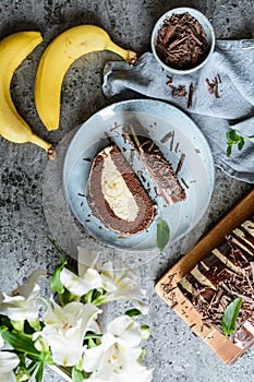 Elephant tears cake stuffed with walnut butter cream and ripe banana and topped with chocolate ganache