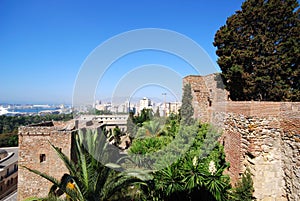 Elevated harbour view with the Christs Gate of Malaga castle in the foreground, Malaga.