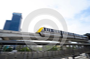 Elevated monorail train fast move on rail. Public transit monorail. Modern mass transit. Rail transportation. Driverless straddle photo