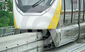 Elevated monorail train on rail. Guide wheels rubber tire on concrete guideway beam with conductor rail. Monorail technology.