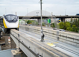 Elevated monorail train on rail. Public transit monorail. Modern mass transit. Rail transportation. Driverless straddle monorail photo