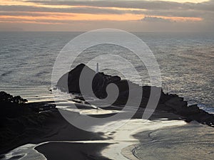 Panorama view of seaside Castle Point Lighthouse on steep cliff hill, Tasman Sea Pacific Ocean Wellington New Zealand