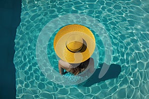 Elevated Pool Relaxation: Aerial View of Woman with Yellow Hat in Swimming Pool