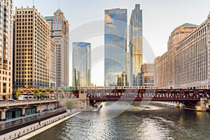 Elevated train crossing a bascule bridge over Chicago river at sunset in spring