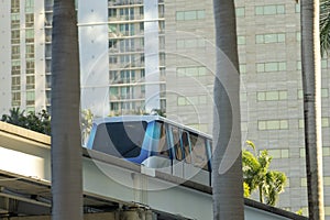 Elevated train for public transportation in Miami city downtown in Florida USA. Metrorail train car on high railroad
