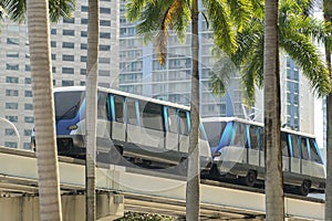 Elevated train for public transportation in Miami downtown district in Florida USA. Metrorail train car on high railroad