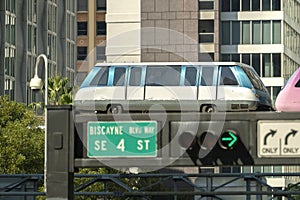 Elevated train for public transportation in Miami downtown district in Florida USA. Metrorail train car on high railroad